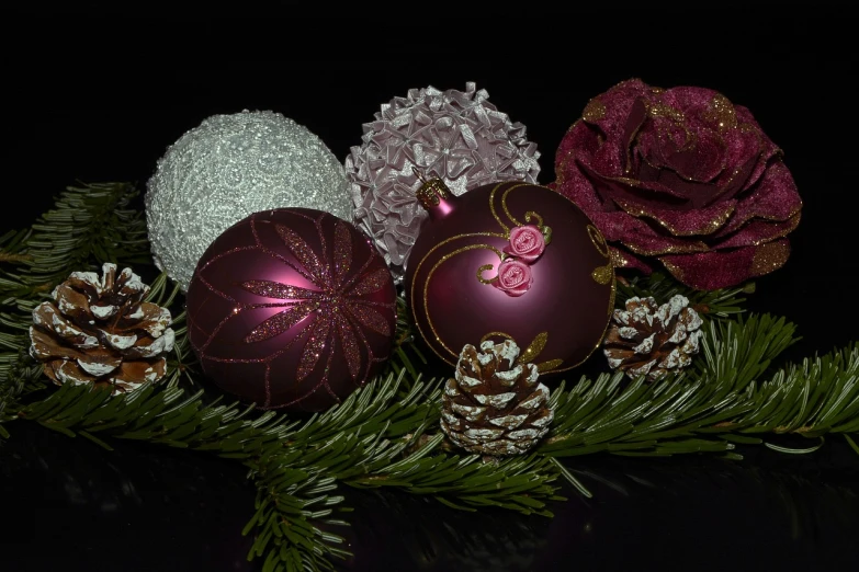a close up of a bunch of ornaments on a tree, a still life, by Maksimilijan Vanka, pixabay, on black background, - h 1 0 2 4, maroon metallic accents, rosses