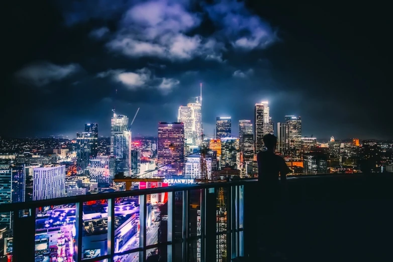 a view of a city at night from the top of a building, iphone wallpaper, los angeles, cyberpunk apartment, people at night