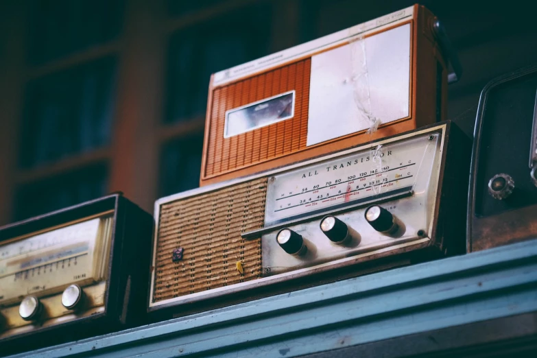 an old fashioned radio sitting on top of a shelf, by Konrad Witz, unsplash, transmitters on roof, various posed, in retro colors, zoomed in