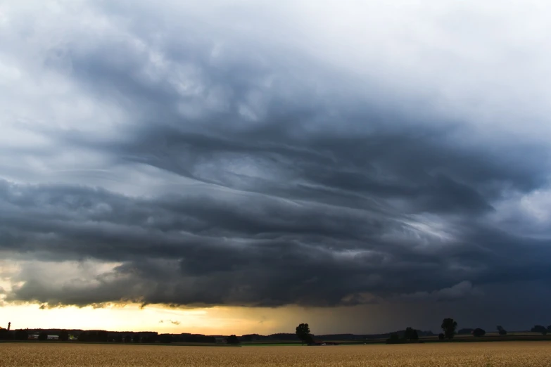 a storm moves across the sky over a wheat field, a picture, by Karl Pümpin, undulating nebulous clouds, lined up horizontally, in forcasted sky, mothership in the sky