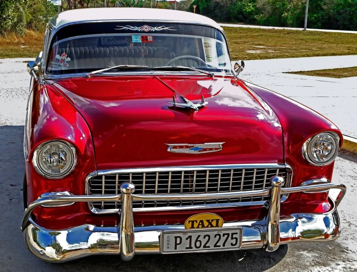 a red classic car parked in a parking lot, a portrait, by Tom Carapic, pixabay contest winner, varadero beach, full of colors and rich detail, taxi, 1957 chevrolet bel air