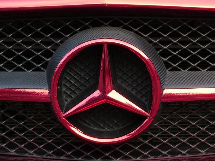 a close up of a mercedes logo on a car, by Thomas Häfner, pexels, precisionism, crimson - black color scheme, photorealism. trending on flickr, in style of mike savad”, menacing!!!