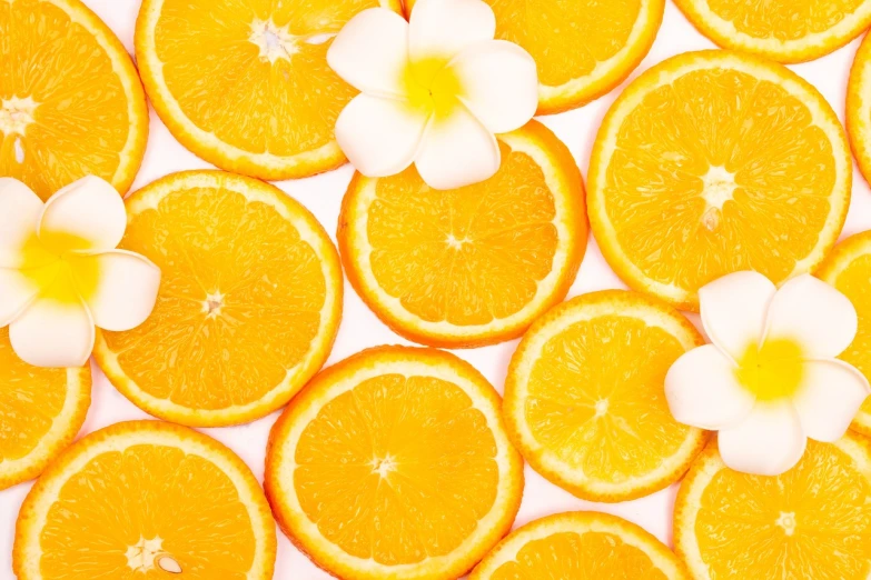 a bunch of orange slices with a flower on top, a stock photo, minimalism, background image, high quality product image”