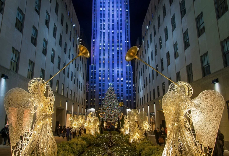 a group of angel statues in front of the rockefeller rockefeller rockefeller rockefeller rockefeller rockefeller rockefeller rockefeller rockefeller rockefeller rockefeller rockefeller rockefeller rockefeller rockefeller rockefeller rockefeller rockefeller rockefeller, by Dennis Flanders, lush tress made of city lights, 3580780586, getty images, photo taken in 2018