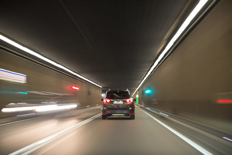 a car driving through a tunnel at night, a picture, by Thomas Häfner, shutterstock, indoor shot, stock photo, tourist photo, high detailed photo