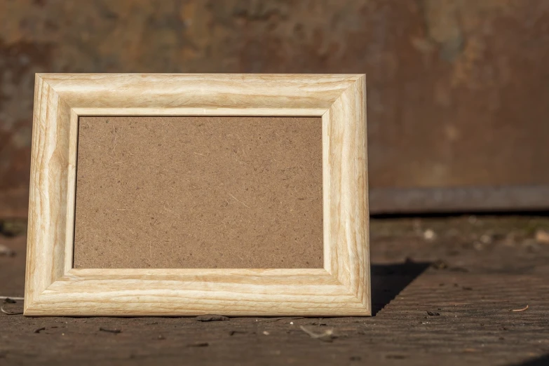 a picture frame sitting on top of a wooden table, by Richard Carline, flickr, wood burn, middle close up shot, miniature product photo, square pictureframes
