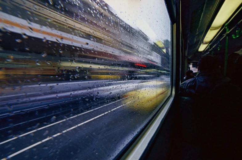 a view out the window of a train on a rainy day, a picture, by Werner Gutzeit, car moving fast, uv, bus stop, craig wylie