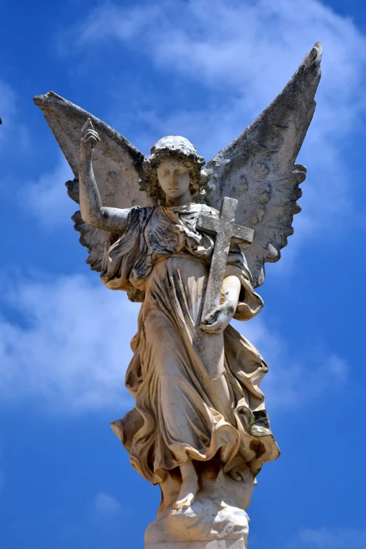 a statue of an angel on top of a building, by Marie Angel, pixabay, baroque, emma watson as an angel, lady of elche, crucifix, wikimedia commons