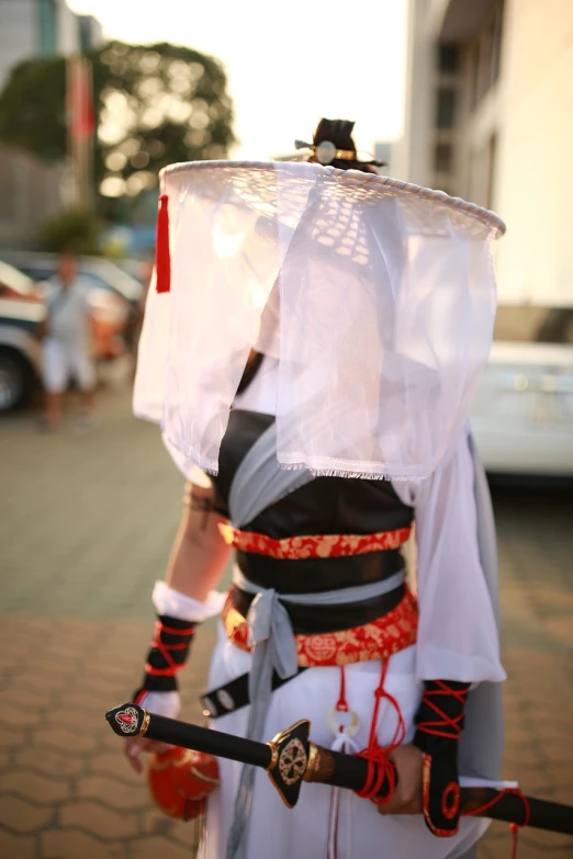 a close up of a person wearing a costume, inspired by Ma Shi, shin hanga, ancient city streets behind her, very accurate photo, summer evening, maid costume