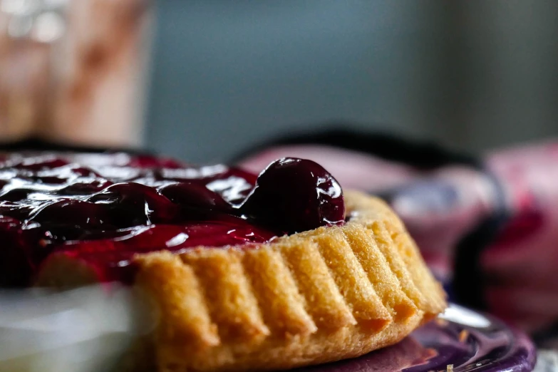 a close up of a pastry on a plate, a picture, by Dietmar Damerau, pexels, photorealism, cherry, cheeks, hard lighting!, ready to eat