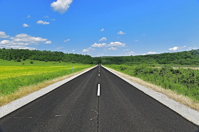 a long empty road in the middle of a field, a picture, pixabay, postminimalism, on a bright day, benjamin vnuk, construction, some of the blacktop is showing