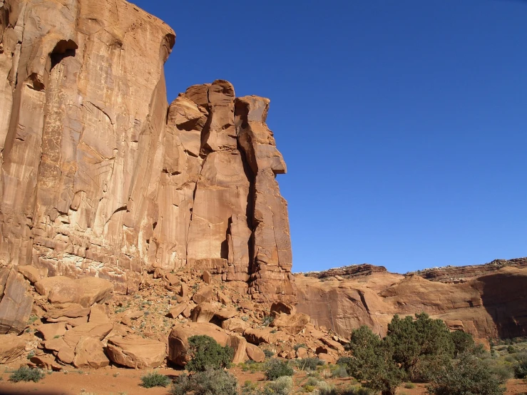 a large rock formation in the middle of a desert, by Linda Sutton, flickr, les nabis, monument valley, natural cave wall, narrow face, conglomerate!