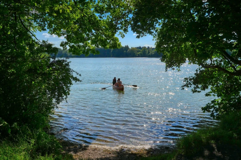 a couple of people in a boat on a lake, by Karl Hagedorn, pixabay, sunny day in the forrest, people swimming, lower saxony, ❤🔥🍄🌪