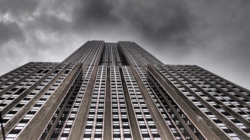 a very tall building with lots of windows, a picture, by Andrei Kolkoutine, unsplash, stormy skies, metropolis filmic gotham city, star wars architecture, the sky is gray