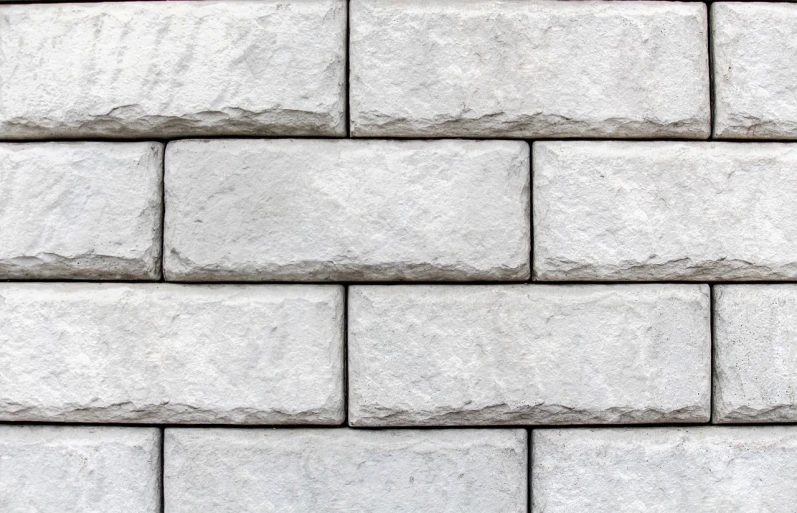 a close up of a brick wall with a fire hydrant, an ambient occlusion render, shutterstock, bauhaus, white stone wall background, rectangular face, grey cobble stones, perfect symmetrical