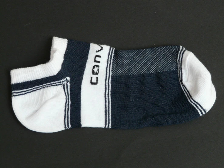 a pair of socks sitting on top of a table, inspired by Cornelis de Man, flickr, sōsaku hanga, tennis wear, ultra view angle view, calvin klein, blue white colors