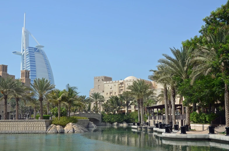 a body of water with palm trees and buildings in the background, shutterstock, dau-al-set, tanned ameera al taweel, lush oasis, award winning ”, dolman