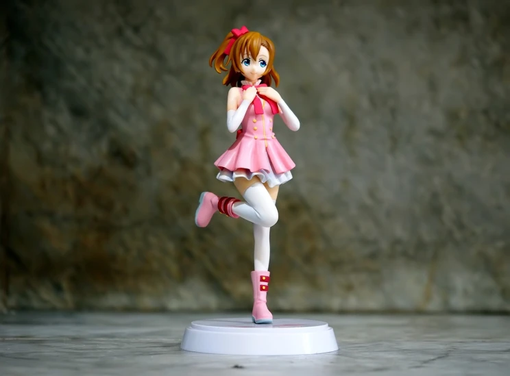 a figurine of a girl in a pink dress, a statue, inspired by Hasegawa Settan, symphogear, smiling and dancing, product introduction photos, she is dancing. realistic