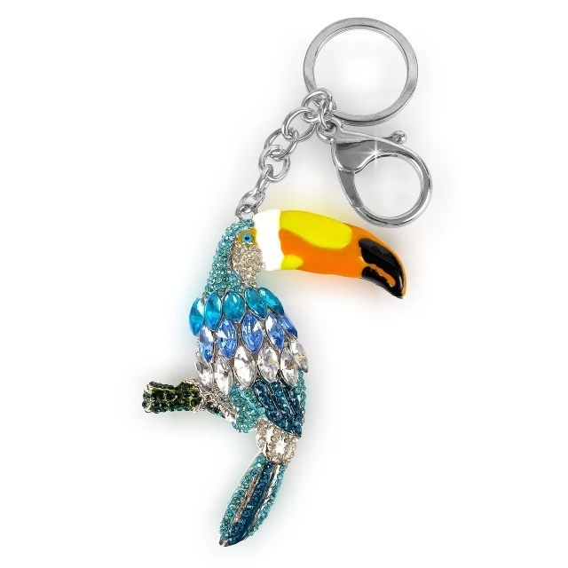 a close up of a key chain with a bird on it, inspired by Charles Bird King, shutterstock, swarovski style, toucan, high detail product photo, - h 7 0 4