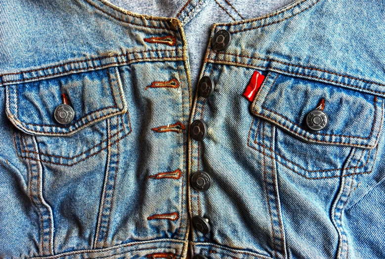 a close up of a jean jacket on a mannequin mannequin mannequin mannequin mannequin mannequin mann, a macro photograph, inspired by Bruce Gilden, photorealism, blue colors with red accents, mini jeans skirt, top down view, photorealism. trending on flickr