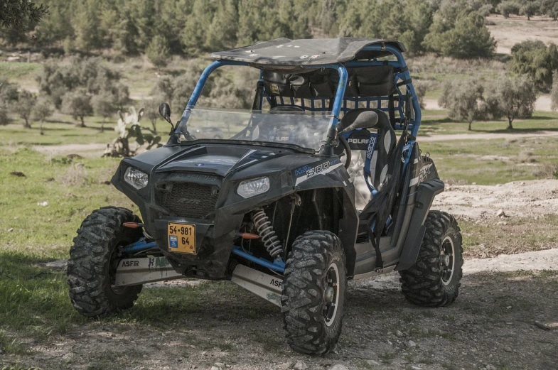 a utv parked on the side of a dirt road, by Mathias Kollros, dau-al-set, front side full, high quality product image”