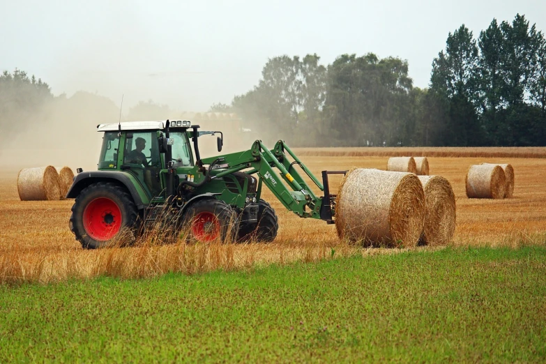 a tractor in a field with hay bales, shutterstock, overcast weather, warping, taken with a pentax k1000, 2 0 1 0 photo