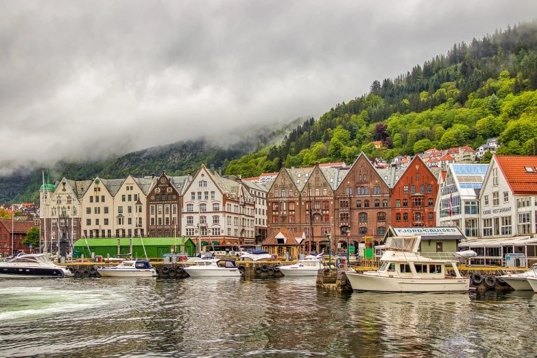 a number of boats in a body of water, a picture, by Ejnar Nielsen, shutterstock, renaissance, mossy buildings, low clouds after rain, stock photo, boka