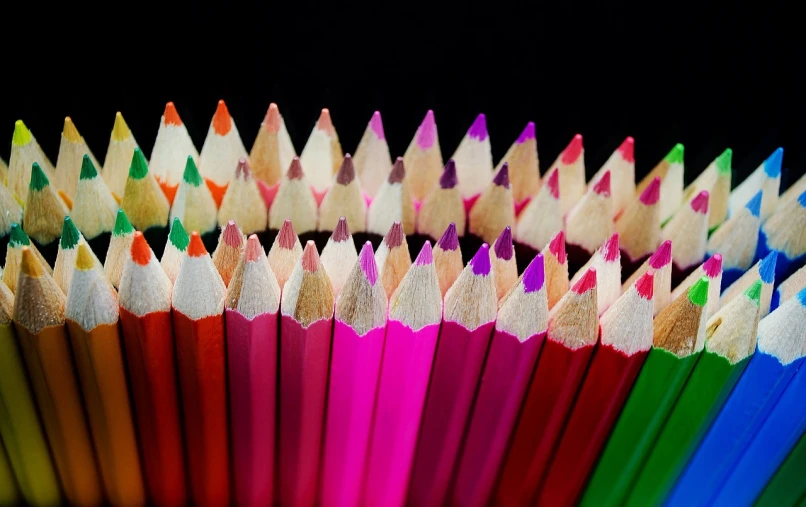 a close up of a bunch of colored pencils, by Richard Carline, pink and red color style, shot with sigma f / 4. 2, symmetry!!, playful composition canon