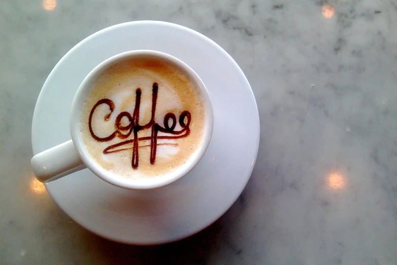 a cup of coffee with the word coffee written on it, a photo, by Alexander Robertson, flickr, marker”, [ [ hyperrealistic ] ], tastes, cappuccino