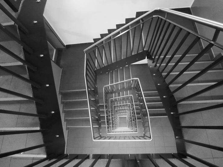 a black and white photo of a spiral staircase, a black and white photo, inspired by MC Escher, bauhaus, wyndham lewis. behance, tri - x pan stock, stairs to the second floor, photo taken in 2018