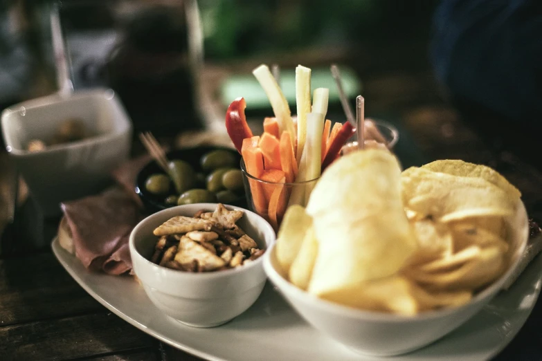 a close up of a plate of food on a table, pexels, crisps, olive, shot on 16mm film, highres