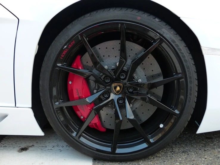 a close up of a tire on a white sports car, inspired by Bernardo Cavallino, black and red color scheme, pink lamborghini aventador, cleaned up, symmetrical front view