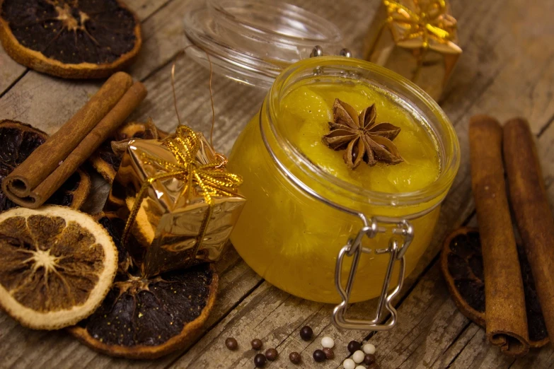 a jar of food sitting on top of a wooden table, a picture, pixabay, renaissance, glossy yellow, festive, soap, glistening body