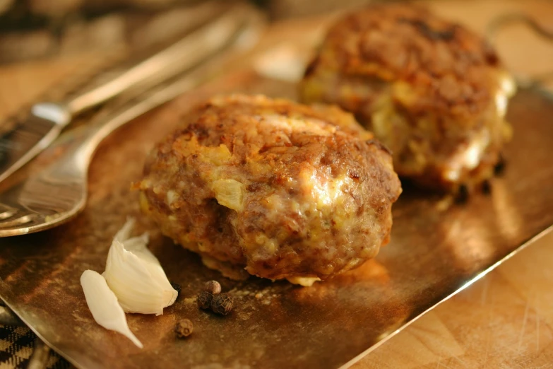 a couple of meatballs sitting on top of a metal tray, by Jan Tengnagel, dau-al-set, meatloaf, traditional corsican, sunny light, cut-away