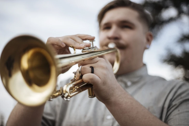 a close up of a person playing a trumpet, a portrait, by Jakob Gauermann, unsplash, sydney hanson, benjamin vnuk, mid portrait, high school