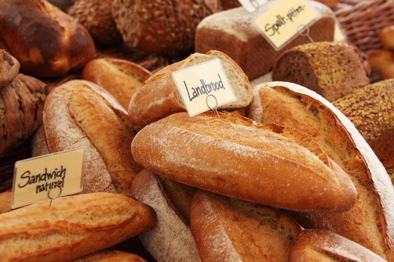 a bunch of bread sitting on top of a table, by Dietmar Damerau, with labels. high quality, istock, lourmarin, ( land )