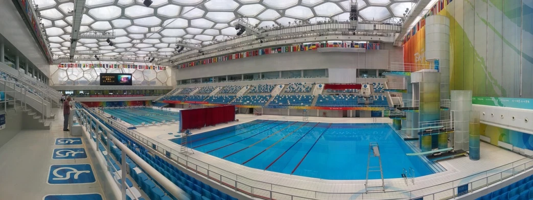 a large indoor swimming pool inside of a building, beijing, stadium setting, reddit post, fisheye 4