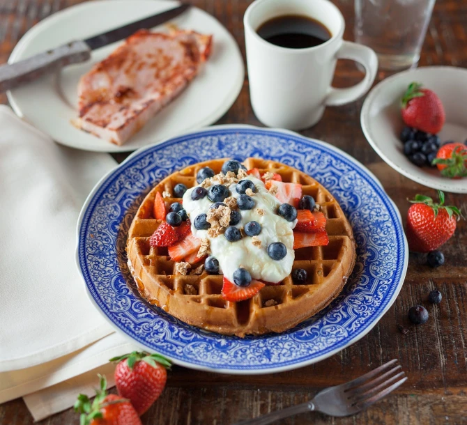 a waffle sitting on top of a blue and white plate, a portrait, shutterstock, rustic, angled shot, usa-sep 20, beautifully painted