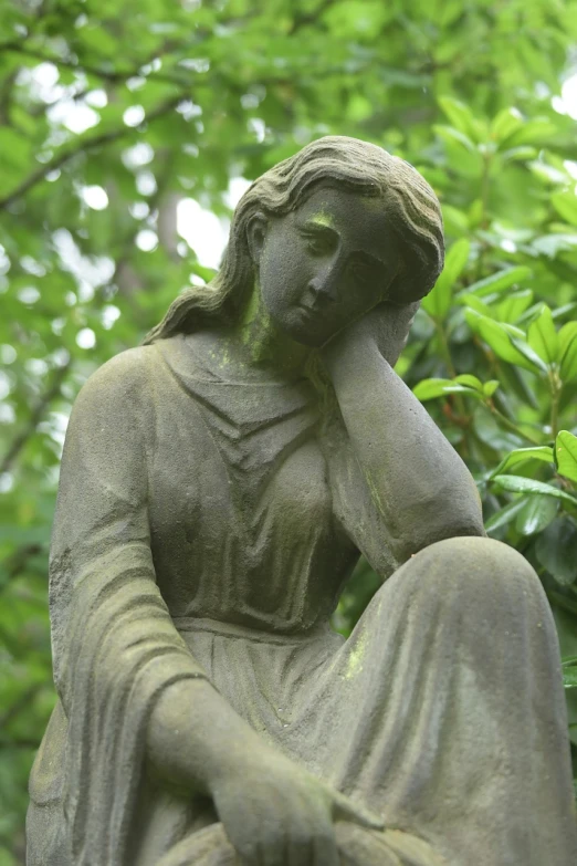 a statue of a woman with her hand on her face, inspired by Elizabeth Shippen Green, pixabay, old cemetery, sitting alone, medium detail, taken in the late 2010s