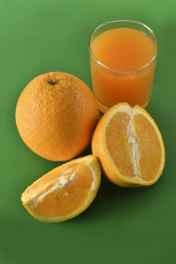 an orange next to a glass of orange juice, a picture, by Josetsu, istockphoto, hyperdetailed!!, emerald, fruitcore