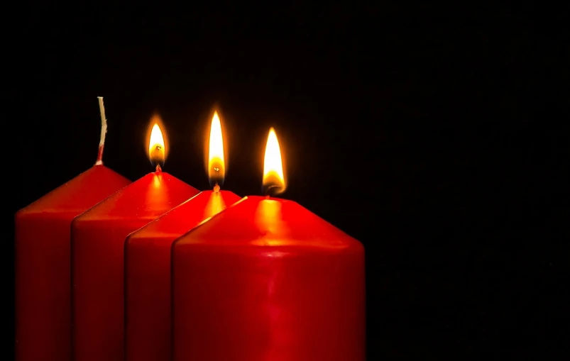 a group of three red candles sitting next to each other, a photo, shutterstock, fine art, in a row, epiphany, four, 3 pm