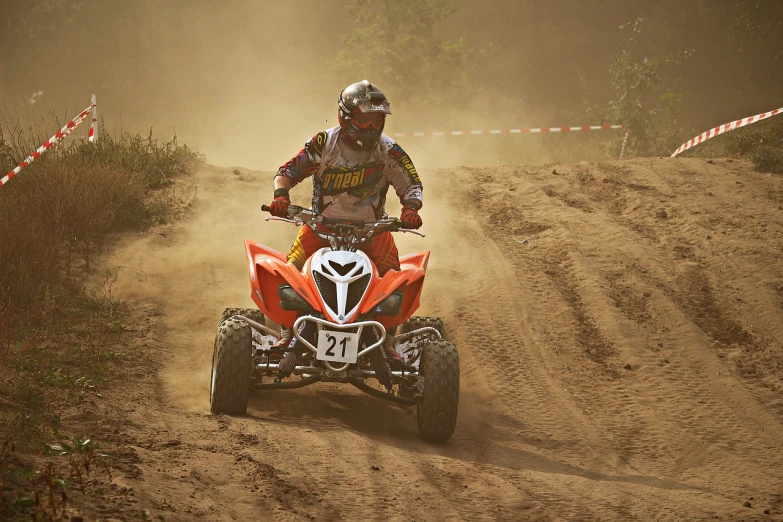 a person riding an atv on a dirt road, a picture, by Aleksander Gierymski, red!! sand, tournament, 8 0 mm camera, damon soule