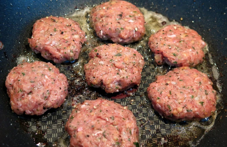 a bunch of meat patties cooking in a frying pan, inspired by Eugène Boudin, flickr, renaissance, crackles, a bald, licking, -640