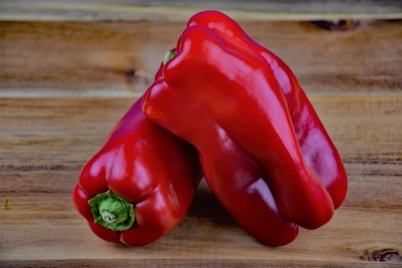 a couple of red peppers sitting on top of a wooden table, renaissance, 6 pack, high quality product image”, profile pic, vegetables