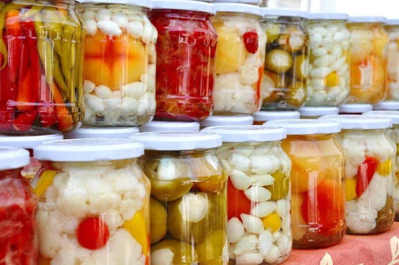 a row of jars of pickled vegetables on a table, a picture, pexels, bauhaus, baked beans, stacked, turkey, white