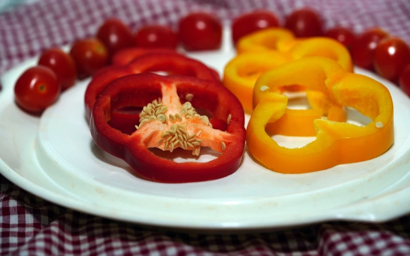 a white plate topped with red and yellow peppers, a picture, pexels, dau-al-set, warm colors--seed 1242253951, also one tomato slice, img _ 9 7 5. raw, red yellow blue