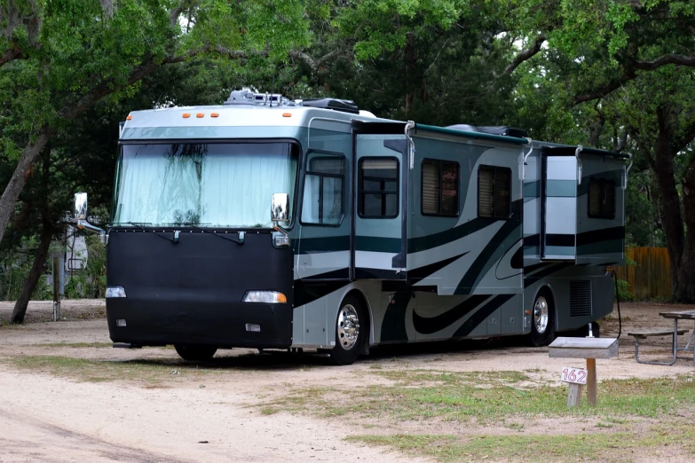 an rv parked on the side of a dirt road, by Douglas Shuler, shutterstock, full front view, an elegant green, tournament, taken in the late 2000s