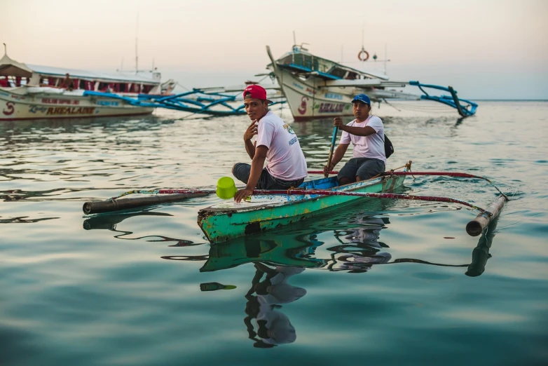 a couple of men riding on top of a green boat, by Richard Carline, pexels contest winner, dau-al-set, manila, waiting to strike, morning glow, shallow depth