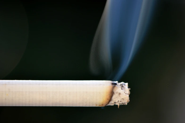a cigarette with smoke coming out of it, shutterstock, taken with a pentax1000, closeup photo, istockphoto, waiting to strike