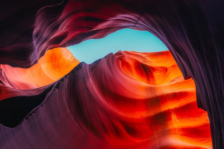 a close up of a rock formation with a blue sky in the background, a microscopic photo, shutterstock, art nouveau, antelope canyon, red silk flowing fabric, vibrant colourful background, shot from above